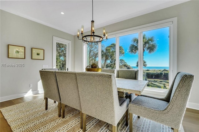 dining space featuring hardwood / wood-style flooring and a chandelier