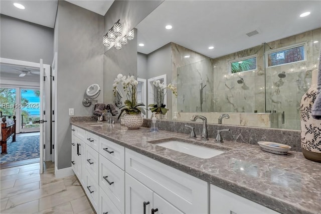 bathroom with a shower with door and vanity