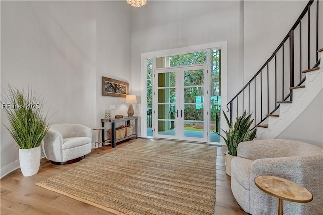 foyer entrance with hardwood / wood-style floors and french doors