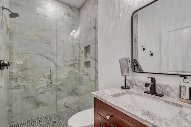 bathroom featuring vanity, toilet, and an enclosed shower