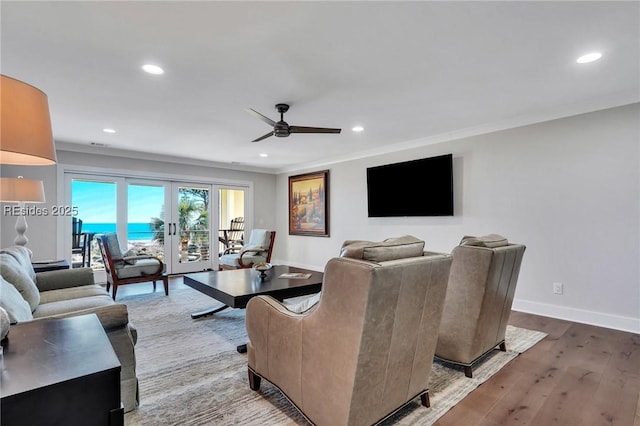 living room featuring crown molding, ceiling fan, wood-type flooring, and french doors