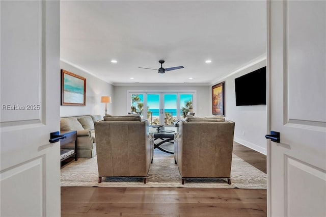 living room featuring crown molding, ceiling fan, and hardwood / wood-style floors