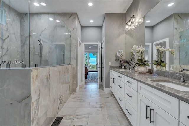 bathroom with vanity and a shower with door