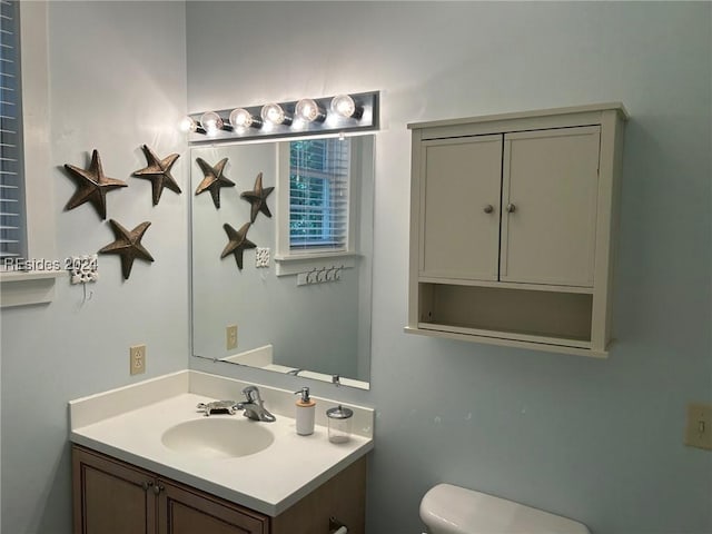 bathroom featuring vanity and toilet