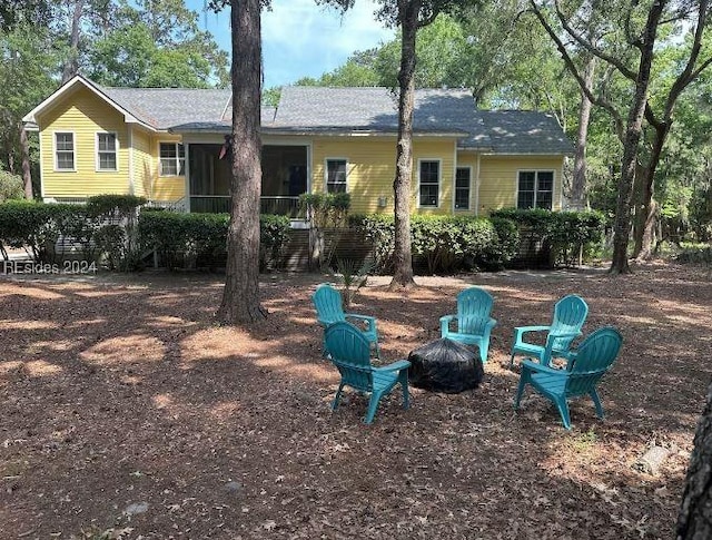 back of house featuring a fire pit