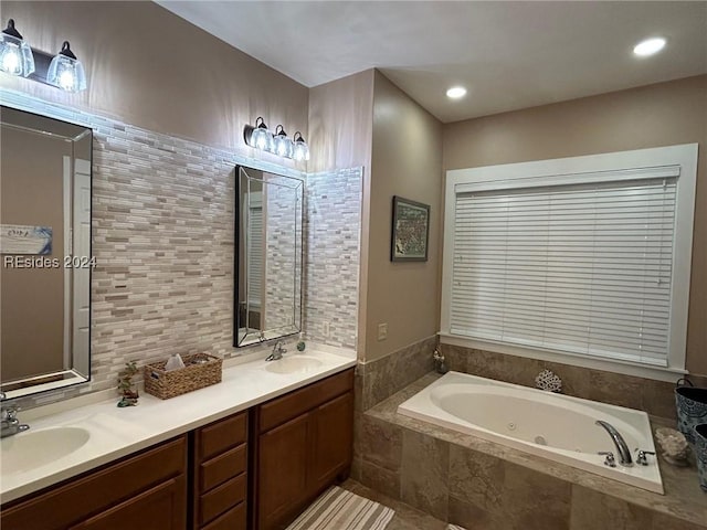 bathroom featuring vanity and tiled bath