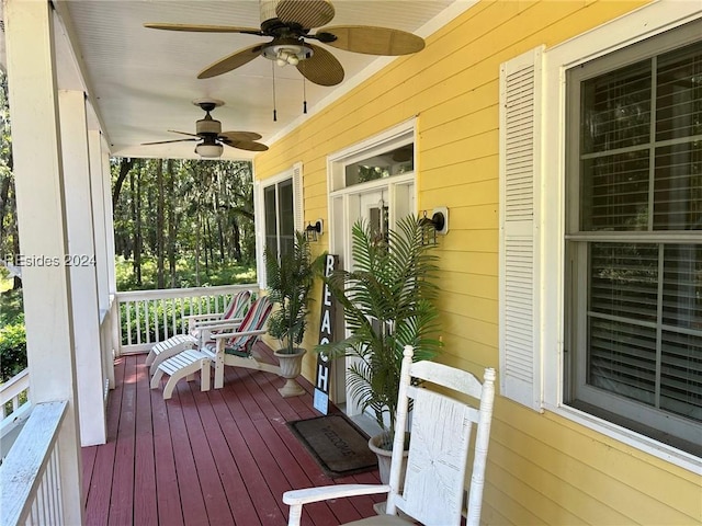 wooden terrace featuring ceiling fan and covered porch