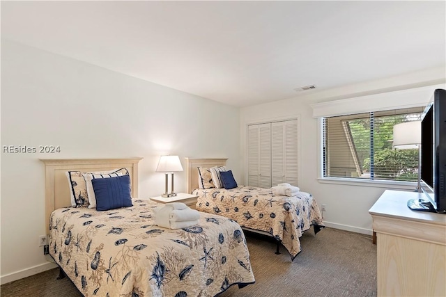 carpeted bedroom with a closet