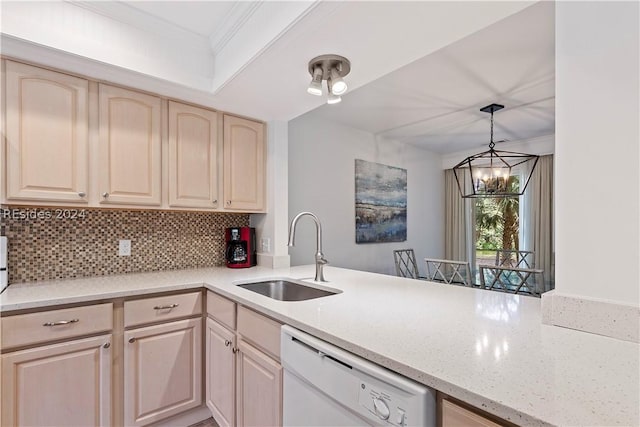 kitchen featuring light brown cabinetry, tasteful backsplash, sink, hanging light fixtures, and white dishwasher