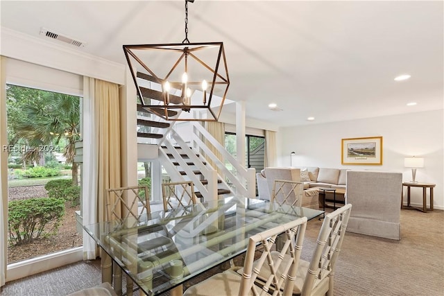 carpeted dining space featuring an inviting chandelier