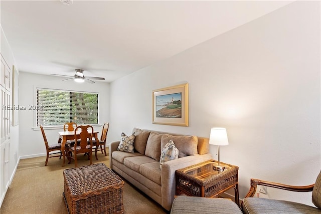 living room with ceiling fan and carpet