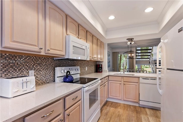 kitchen with light brown cabinetry, decorative backsplash, hanging light fixtures, crown molding, and white appliances