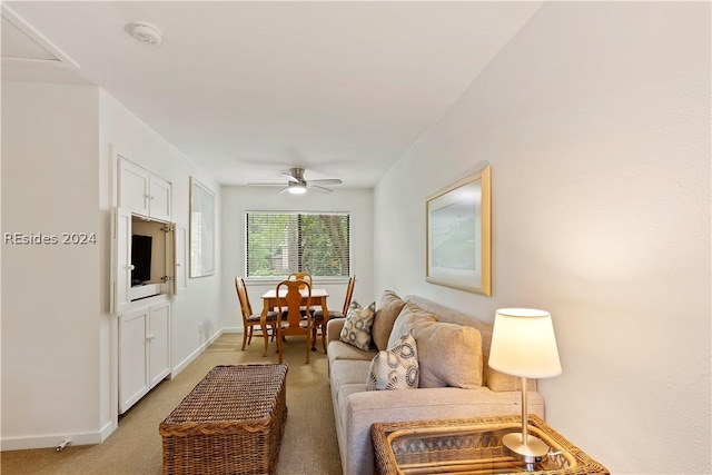 carpeted living room featuring ceiling fan