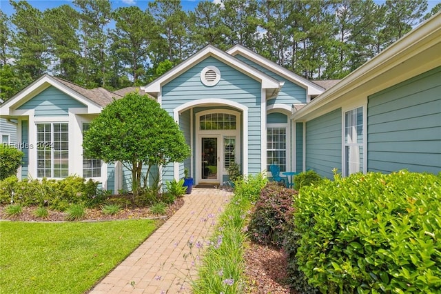 doorway to property with a yard