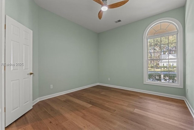 empty room featuring ceiling fan and light wood-type flooring