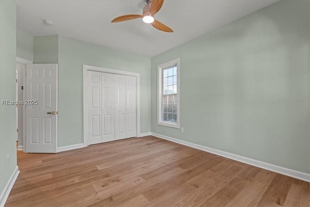 unfurnished bedroom featuring ceiling fan, light hardwood / wood-style floors, and a closet