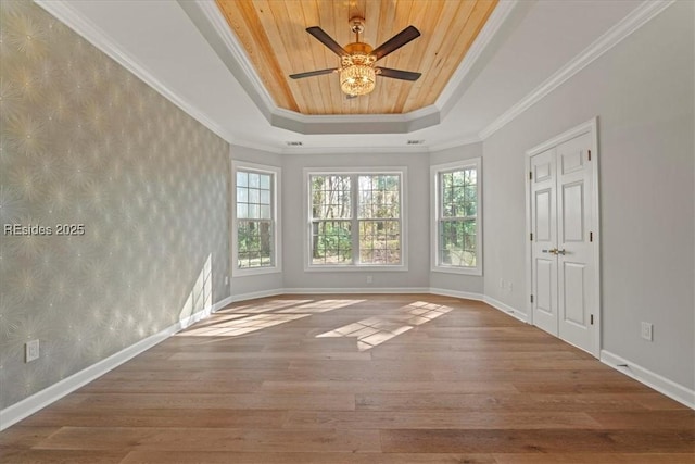 unfurnished room with crown molding, hardwood / wood-style floors, wood ceiling, and a raised ceiling