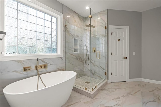 bathroom featuring a healthy amount of sunlight and separate shower and tub