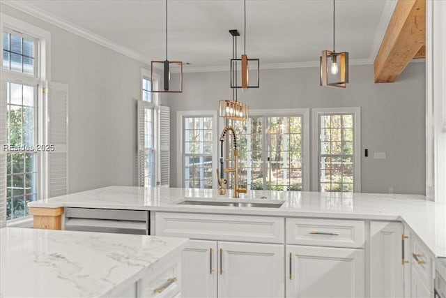 kitchen featuring pendant lighting, sink, dishwasher, light stone countertops, and white cabinets