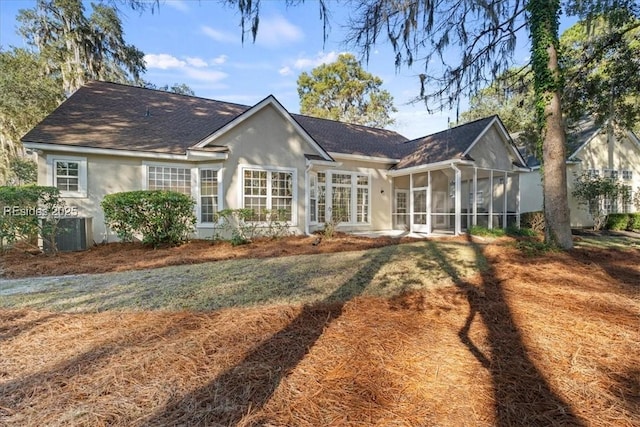 back of house with a yard and a sunroom