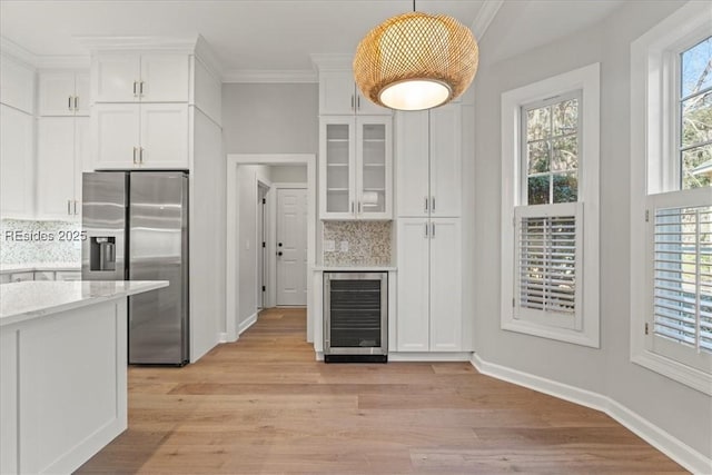 kitchen with stainless steel refrigerator with ice dispenser, white cabinetry, light stone countertops, and wine cooler