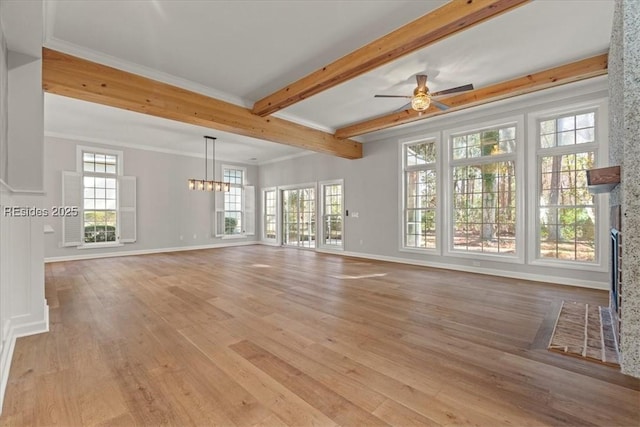 unfurnished living room featuring crown molding, ceiling fan, a brick fireplace, beamed ceiling, and light wood-type flooring