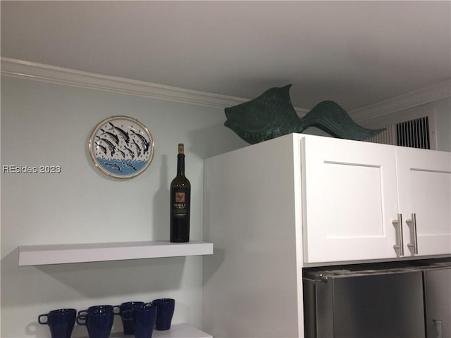 interior details featuring white cabinetry and crown molding