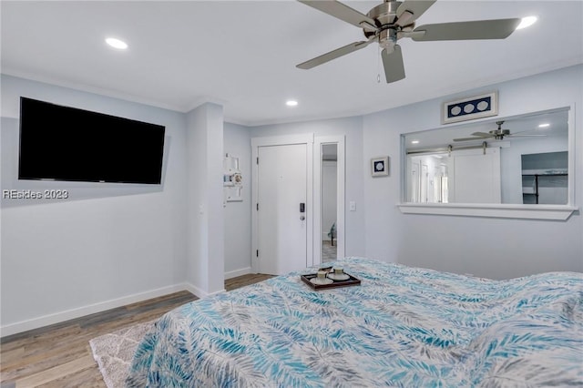 bedroom with wood-type flooring, a closet, and ceiling fan