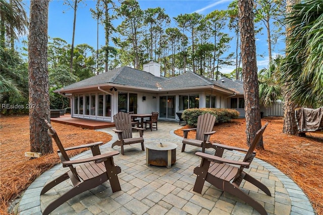 rear view of house with a patio area and an outdoor fire pit