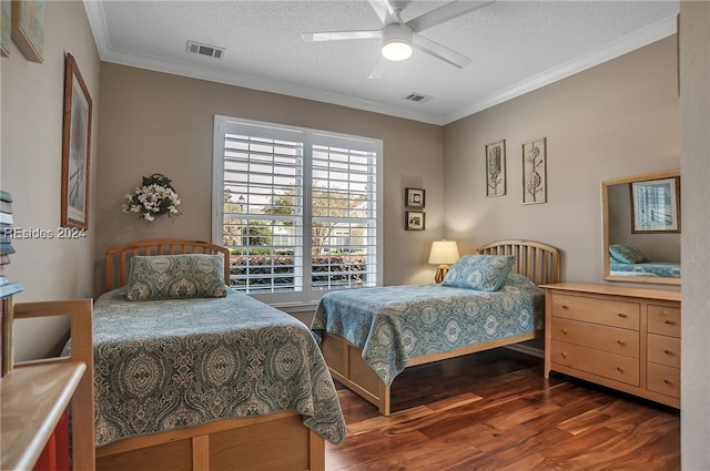 bedroom featuring dark hardwood / wood-style flooring, a textured ceiling, ornamental molding, and ceiling fan