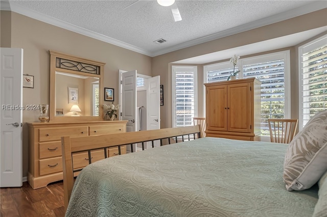 bedroom with multiple windows, ceiling fan, crown molding, dark wood-type flooring, and a textured ceiling