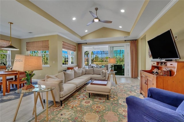 living room with ceiling fan, ornamental molding, lofted ceiling, and light hardwood / wood-style floors