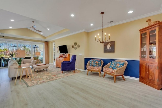 living room with lofted ceiling, ceiling fan with notable chandelier, ornamental molding, and light hardwood / wood-style floors