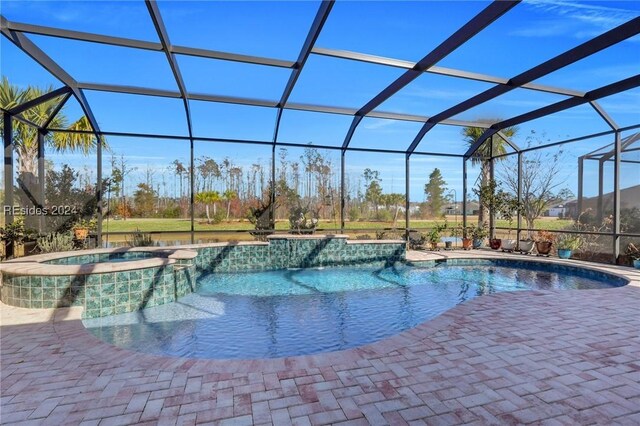 view of swimming pool with a lanai, a patio, and an in ground hot tub