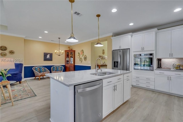 kitchen featuring stainless steel appliances, sink, white cabinets, and light hardwood / wood-style floors