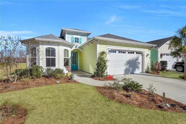 view of front of home featuring a garage and a front lawn