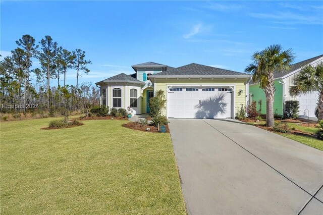 view of front of house featuring a garage and a front yard