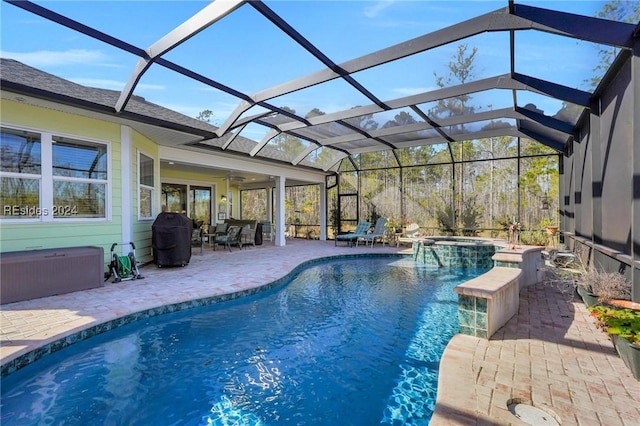 view of swimming pool featuring grilling area, a lanai, a patio area, and an in ground hot tub