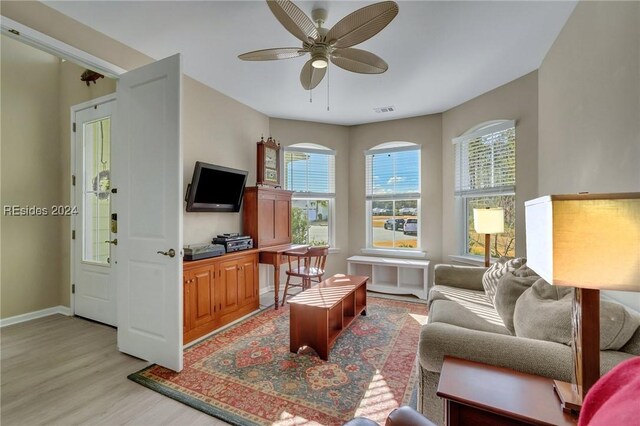 living room featuring ceiling fan and light hardwood / wood-style flooring