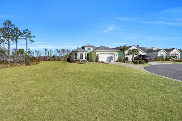 ranch-style home featuring a garage and a front yard