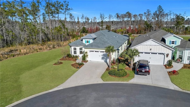 view of front of home with a garage and a front lawn