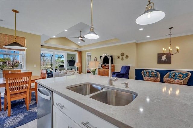 kitchen with light stone counters, stainless steel dishwasher, white cabinetry, and pendant lighting