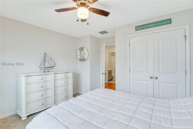 bedroom with light carpet, a closet, and ceiling fan