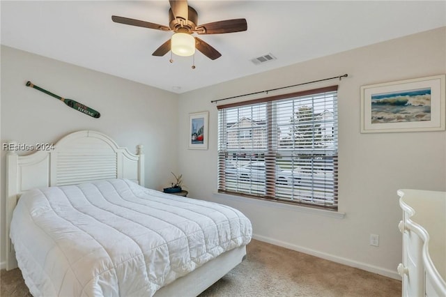 bedroom with ceiling fan and light colored carpet