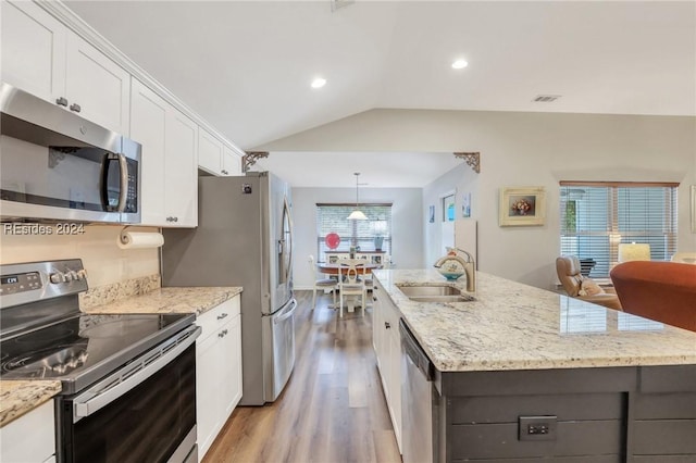 kitchen featuring white cabinetry, wood-type flooring, sink, a kitchen island with sink, and stainless steel appliances