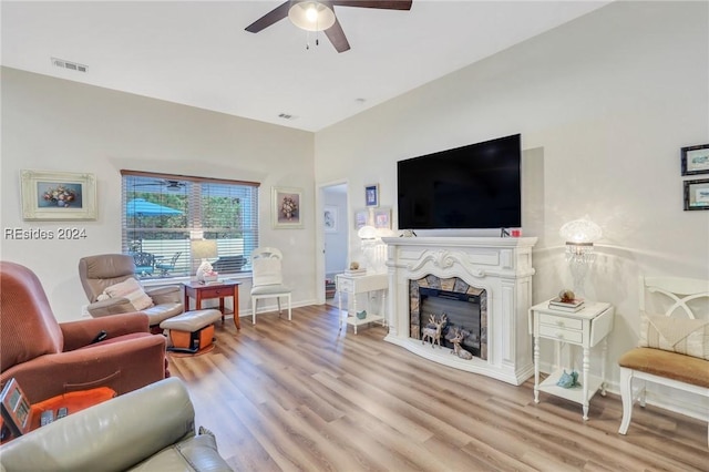 living room featuring ceiling fan and light hardwood / wood-style flooring