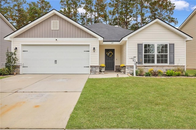 view of front of property with a garage and a front lawn