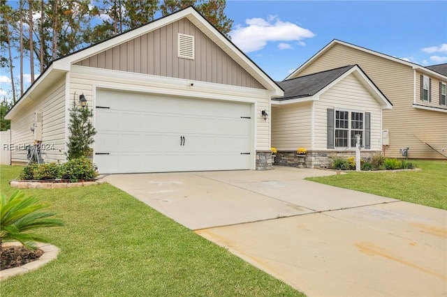 view of front of property with a garage and a front lawn