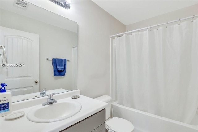 full bathroom with shower / bathtub combination with curtain, vanity, and toilet