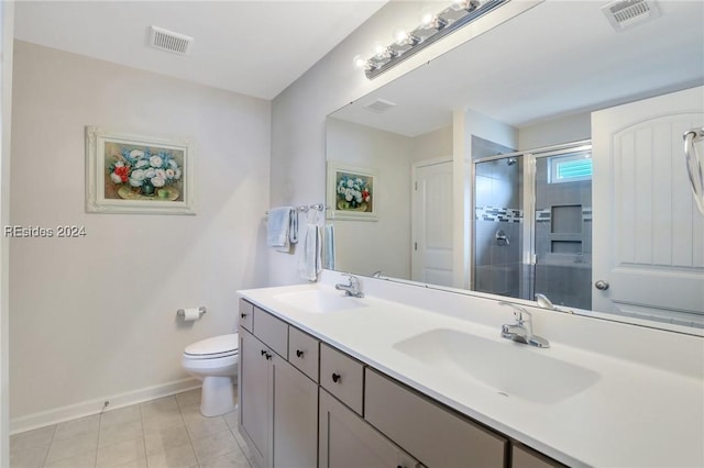 bathroom with a shower with door, vanity, tile patterned flooring, and toilet